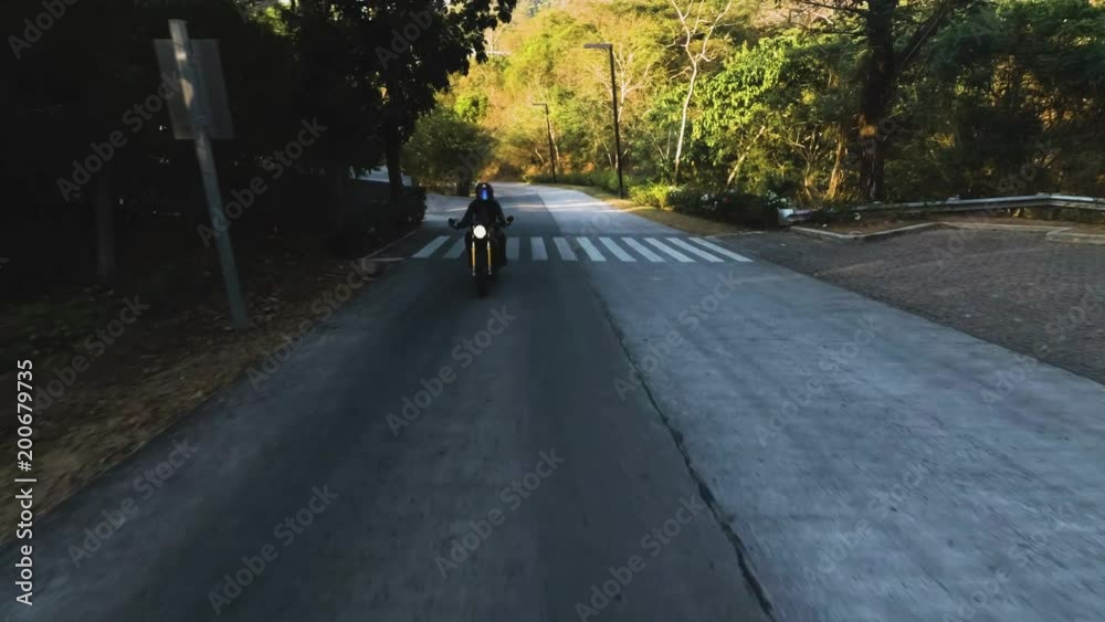 woman riding bike on road near Pico de loro in Philippines