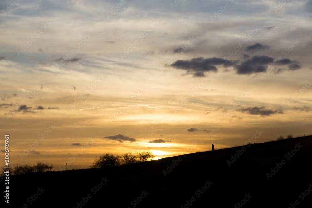 People on the horizon of meadow during sunset. Slovakia