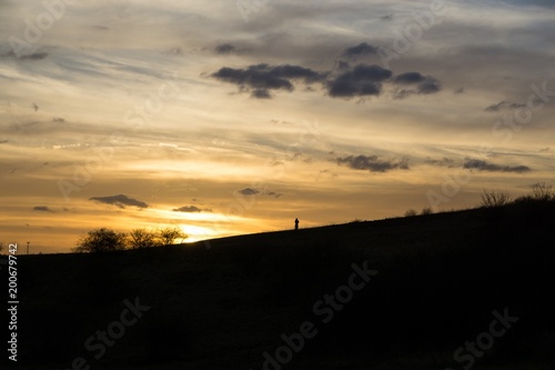 People on the horizon of meadow during sunset. Slovakia