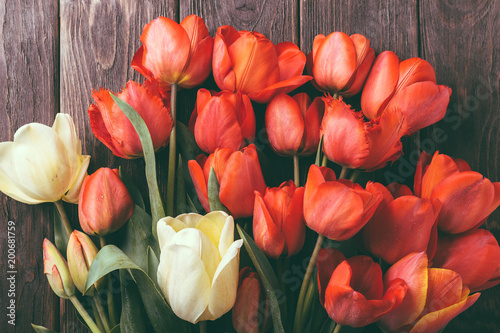 Fototapeta Naklejka Na Ścianę i Meble -  bouquet of red tulips on a wooden background, tulips close-up