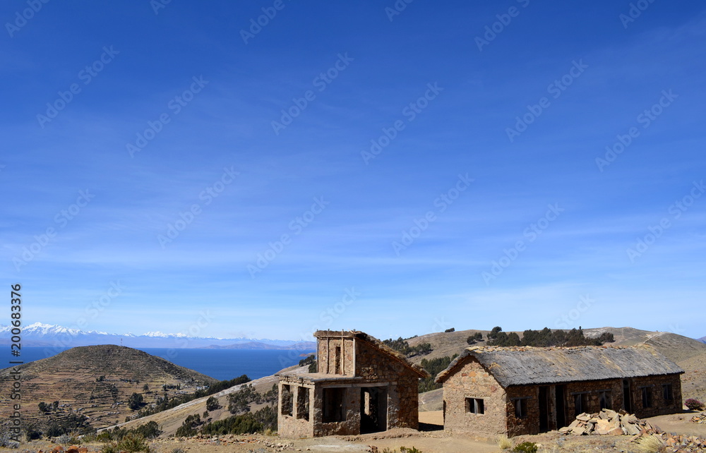 Stone cottage with thatched roof and stable on Isla del Sol in Lake Titicaca, Bolivia.