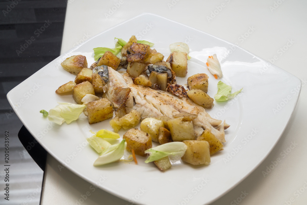 sea bass in the dish with potatoes and salad sea bass in the dish with potatoes and salad