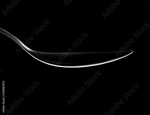 Spoon outline highlight om a black abstract background