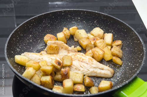 sea bass cooks with potatoes