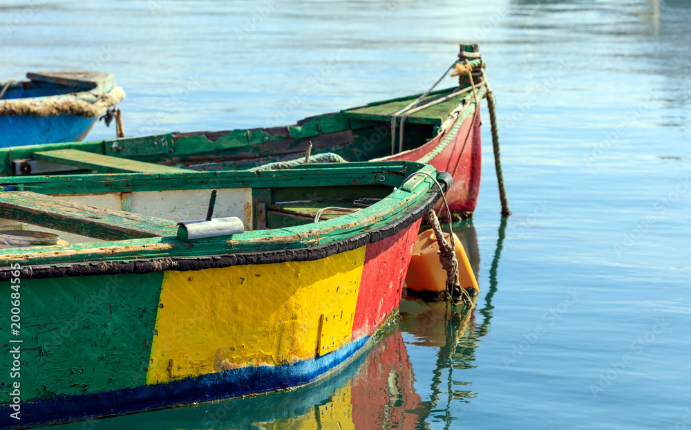 Fototapeta premium Traditional colorful boats luzzu at the port of Marsaxlokk, Malta. Copy space, closeup view