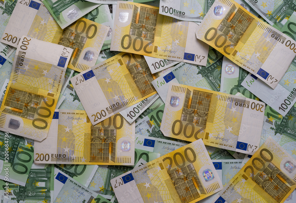 Scattered 200 euro, 100 euro, banknotes - background.