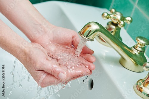 Washing hands. hygiene and dysentery prevention. faucet tap with flowing water photo