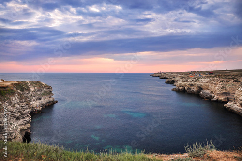 High cliffs of the sea shore. The evening landscape by the sea.