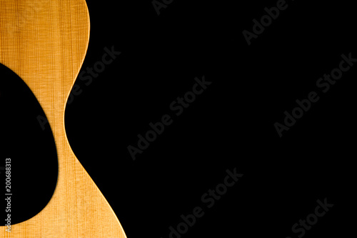 Foto Acoustic Guitar Partial Body on Black Background