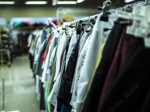 close up clothes hanging row in the store