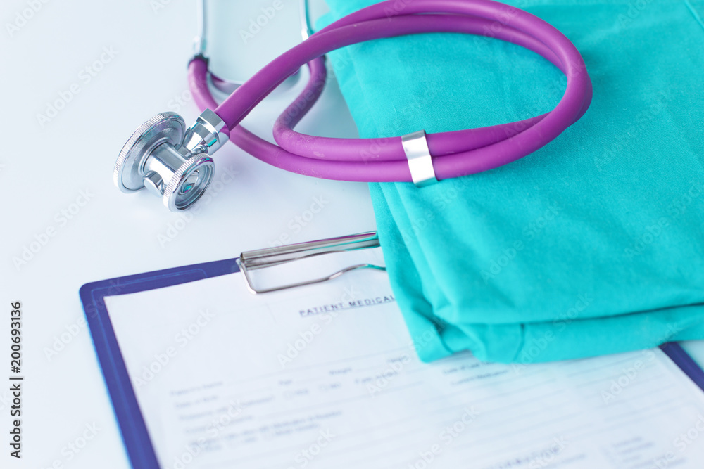 Stethoscope on a table with medical uniform
