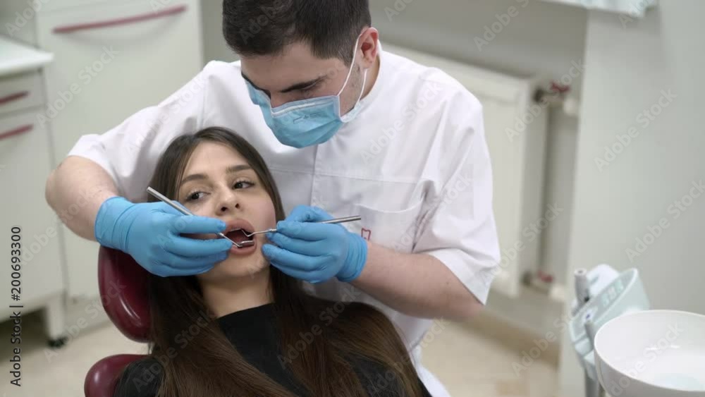 Dentist doctor checking patient teeth in dental clinic Dentist doctor checking patient teeth in dental clinic