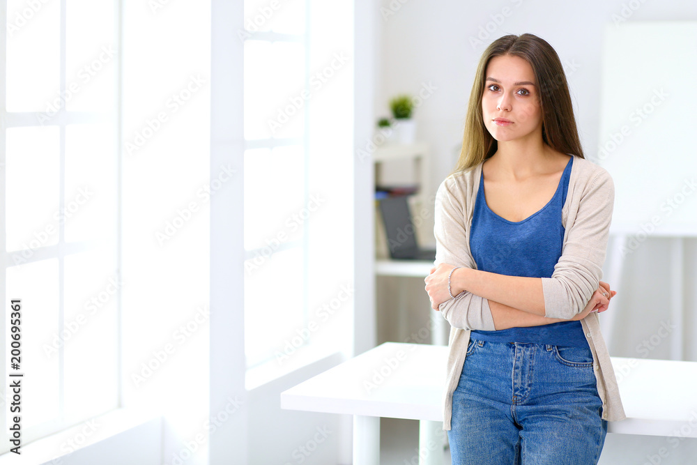 Attractive young woman standing in white studio Attractive young woman standing in white studio