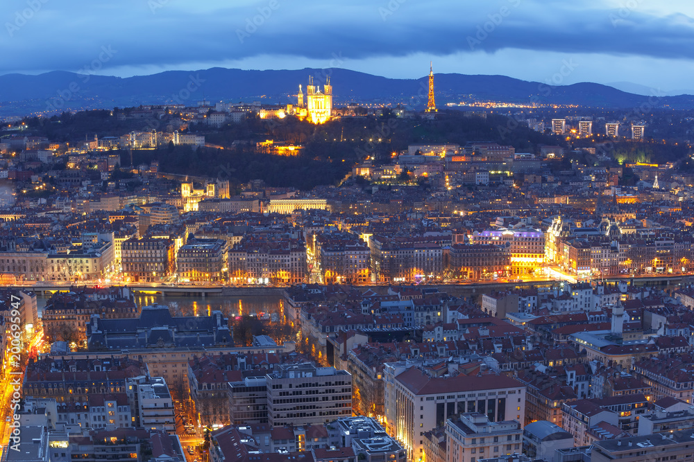 Aerial view of Old town with Fourviere cathedral during evening blue hour in Lyon, France