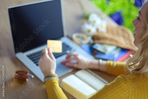Young woman on a coffee break or enjoying the coffee-break, Using laptop computer.