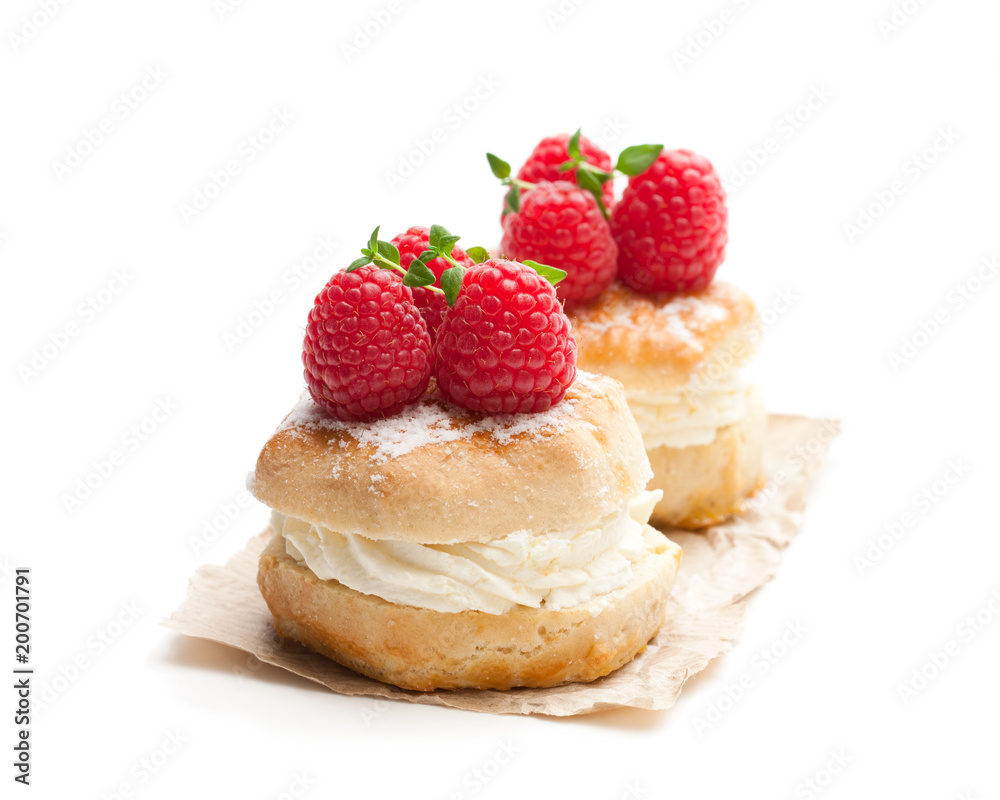 Traditional scones with raspberry and cream isolated on white Traditional scones with raspberry and cream isolated on white