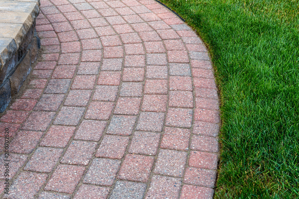 Fototapeta premium Beautiful brick sidewalk with nice grass edge.