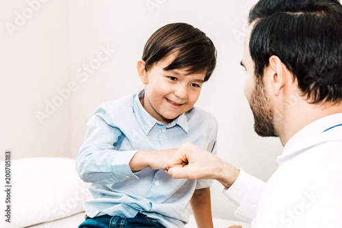 Doctor giving fist bump with patient boy in hospital.healthcare and medicine