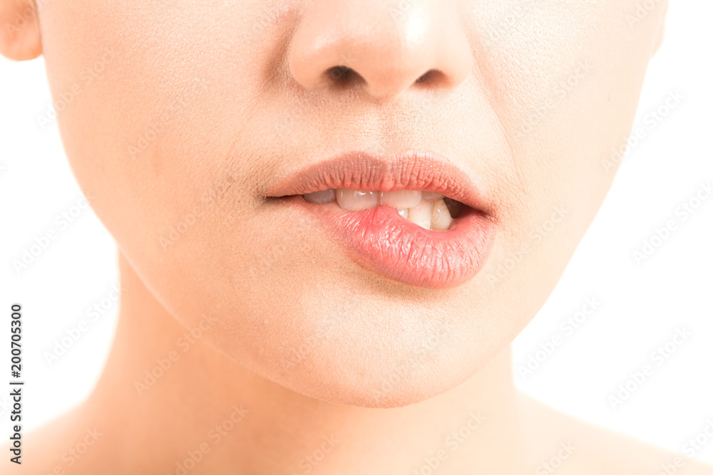 Obraz premium Close-up of female lips mouth biting lip isolated on white background