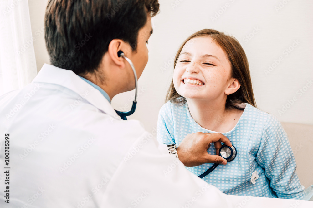 Doctor examining little girl with stethoscope in the hospital.healthcare and medicine Doctor examining little girl with stethoscope in the hospital.healthcare and medicine