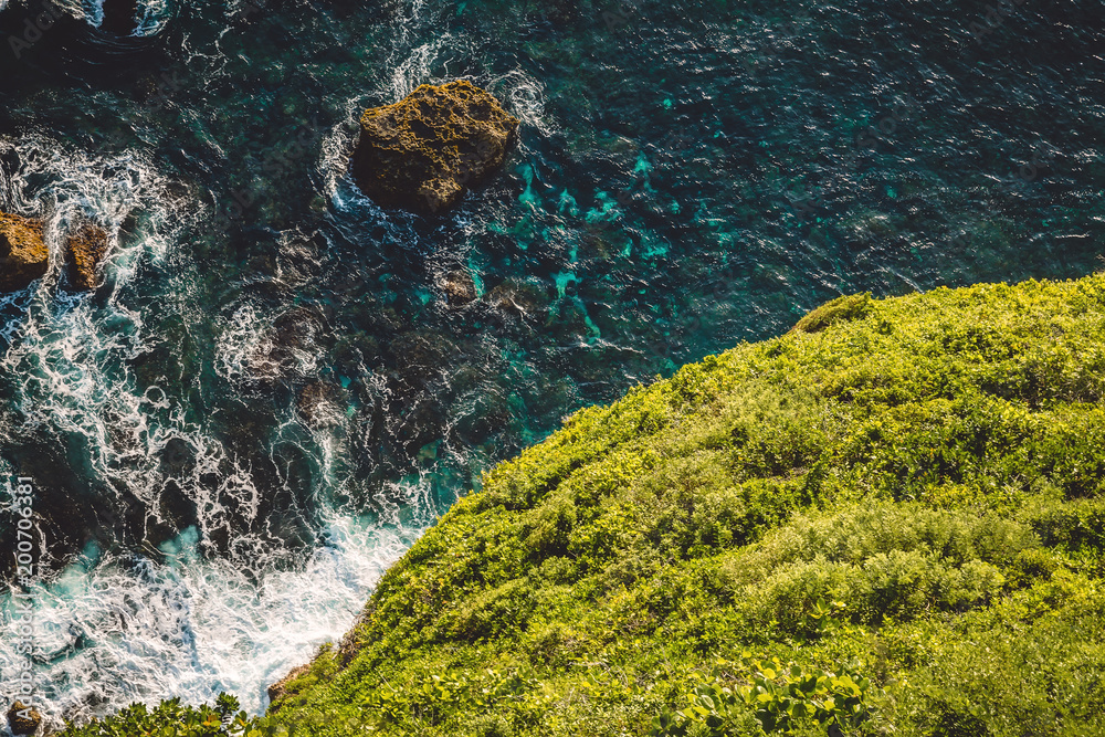 Fototapeta premium Ocean, waves and cliff in Uluwatu, Bali