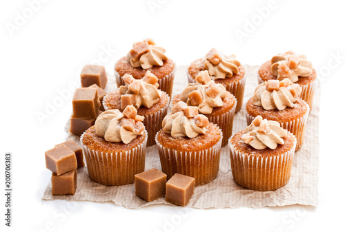 Toffee cupcakes with white cream isolated on white