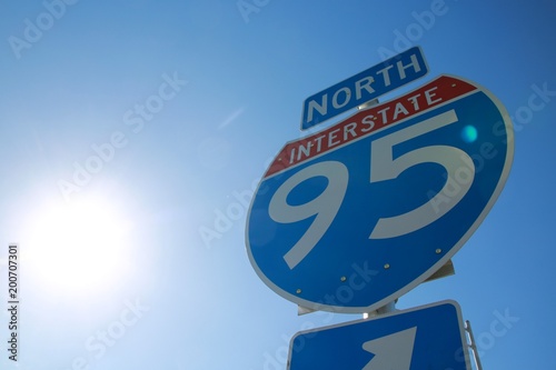 I-95 North Sign Backlit by Sun Against Clear Blue Sky