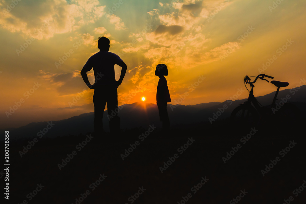 Silhouette man and little girl at sunset time.Child abuse and bullying in the family.
