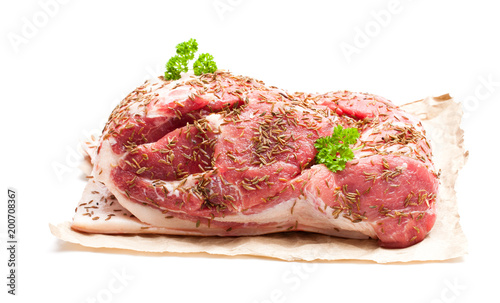 Fresh pork shoulder joint with caraway seeds isolated on white