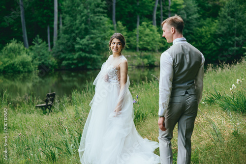 bride and groom posing for a walk in the woods