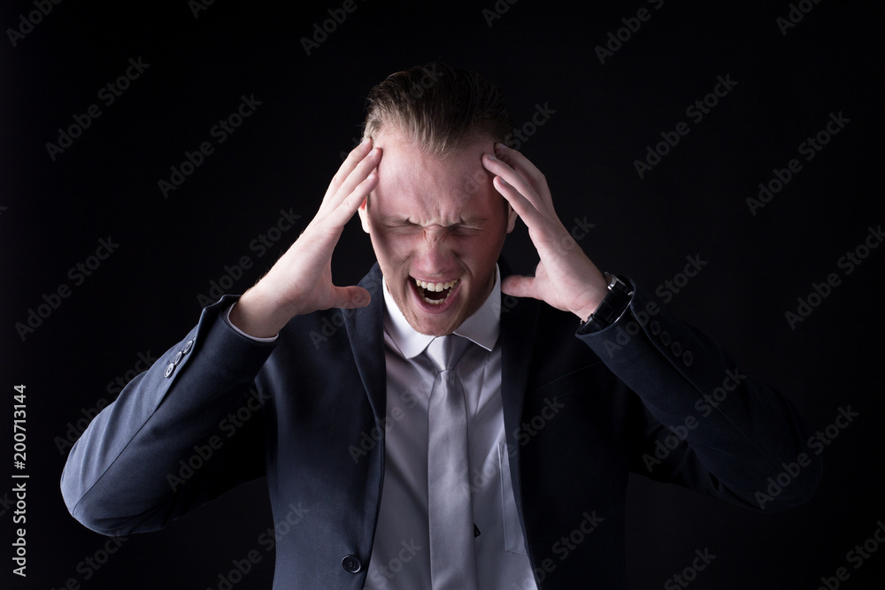 Businessman with angry emotion and shouting isolated in a black background. Businessman with angry emotion and shouting isolated in a black background.