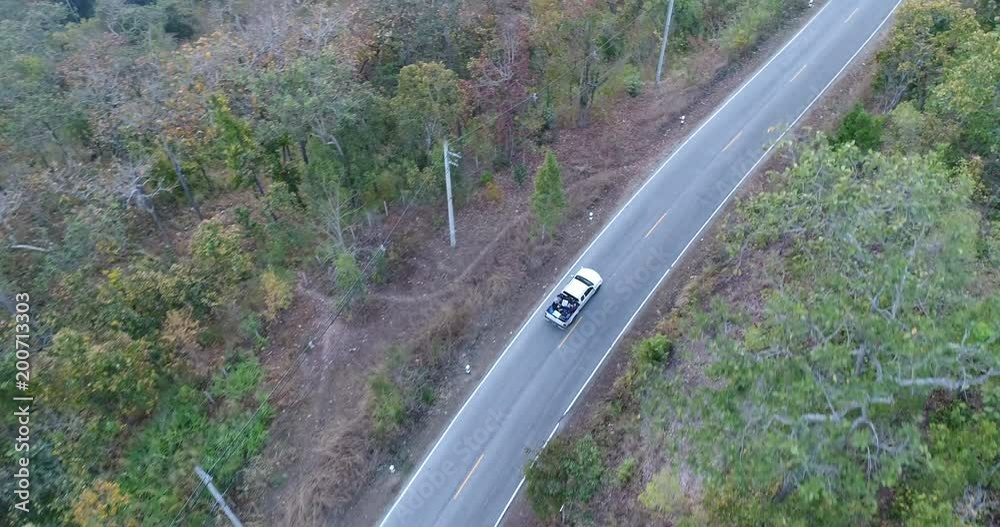 Aerial Shot Of Car Driving Through Forest Road Drone Travel Countryside Adventure Tree Slow Motion Autumn Nature Scenic Sunlight