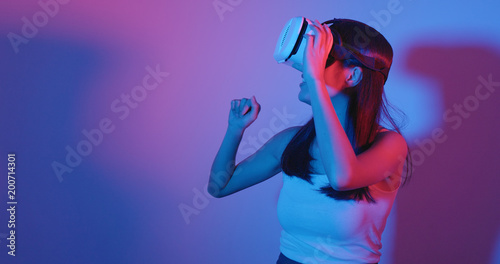 Woman looking though VR headset with red and blue light