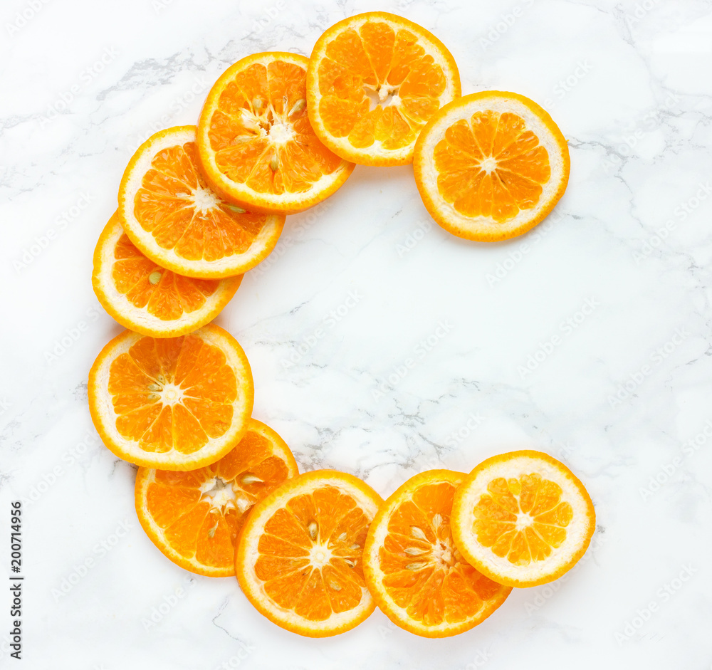 Orange slices vitamin c letter on white background Stock Photo | Adobe Stock