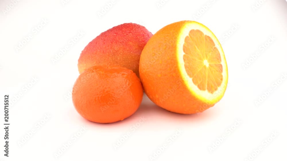 Mango, orange fruit and mandarin fruits rotating on white background. Isolated. Close up. Mango, orange fruit and mandarin fruits rotating on white background. Isolated. Close up.