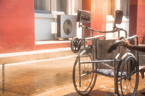 woman cleaning old wheelchair by sponge,asian washing style
