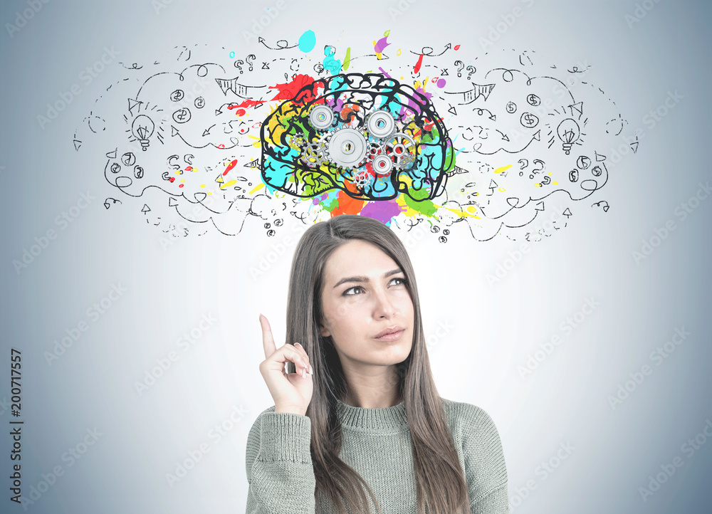 Thoughtful woman in green pointing up, cog brain Thoughtful woman in green pointing up, cog brain