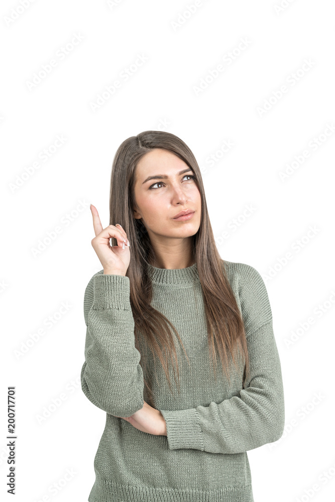 Thoughtful woman in green pointing up, isolated Thoughtful woman in green pointing up, isolated