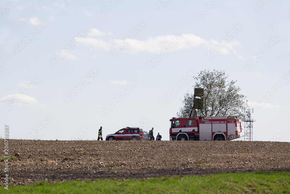 Fototapeta premium VITIN, CZECH REPUBLIC - 14 April, 2018: Firework department checking stack of hay in fire.