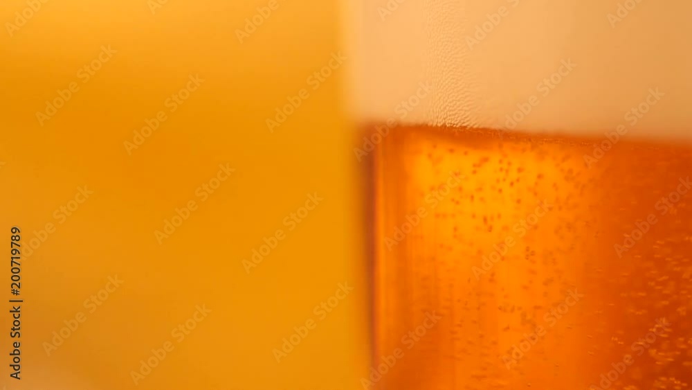 Detail of beer glass with bubbles. Close up beer background, slow motion. Detail of beer glass with bubbles. Close up beer background, slow motion.