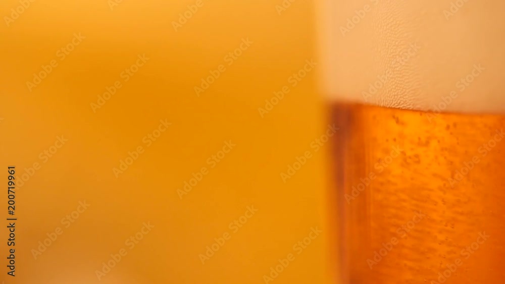 Detail of beer glass with bubbles. Close up beer background, slow motion. Detail of beer glass with bubbles. Close up beer background, slow motion.