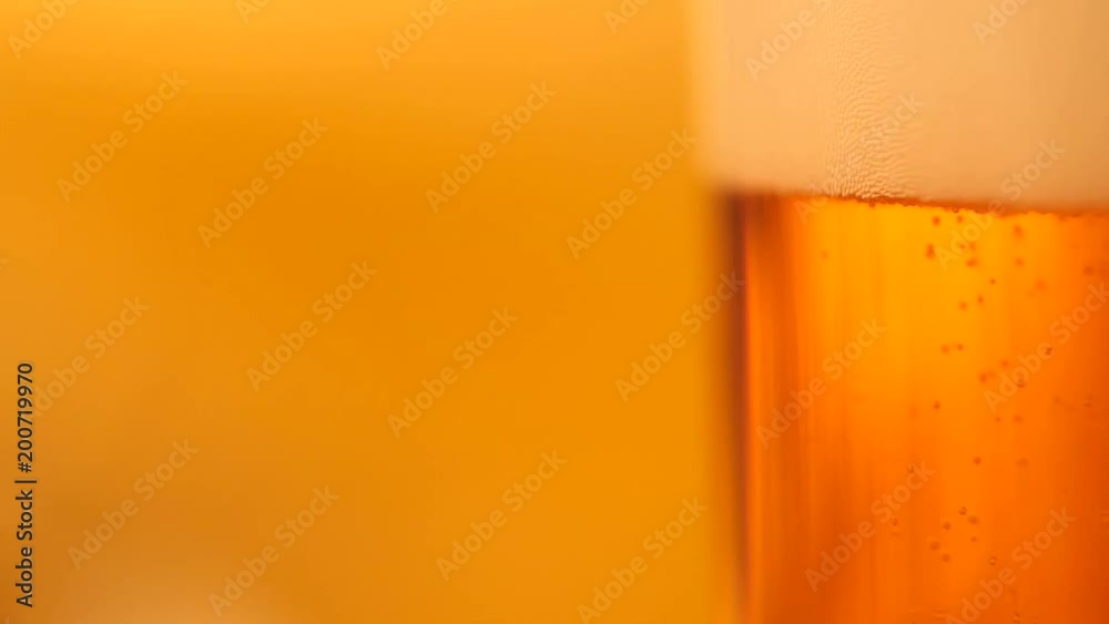 Detail of beer glass with bubbles. Close up beer background, slow motion. Detail of beer glass with bubbles. Close up beer background, slow motion.
