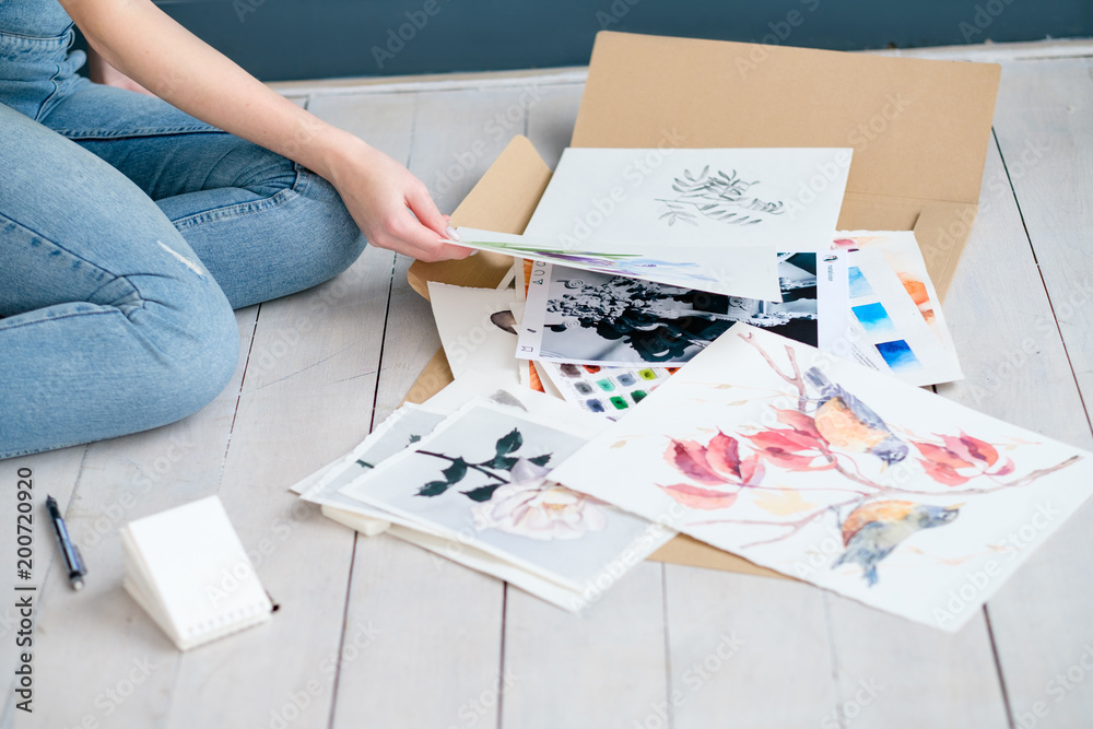 Fototapeta premium creative art lifestyle. drawing hobby and self expression. woman looking through paintings at home