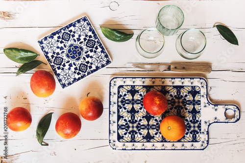 Preparing blood orange juice over white wooden table