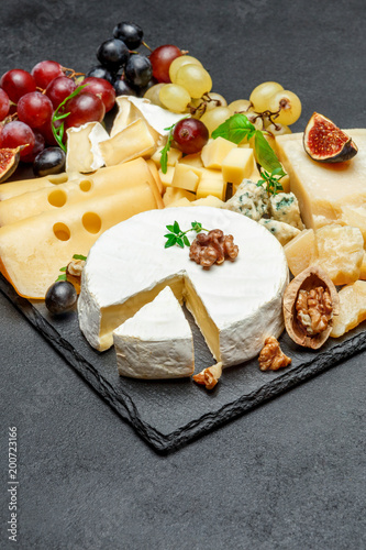 various types of cheese on stone serving board