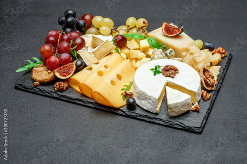 various types of cheese on stone serving board