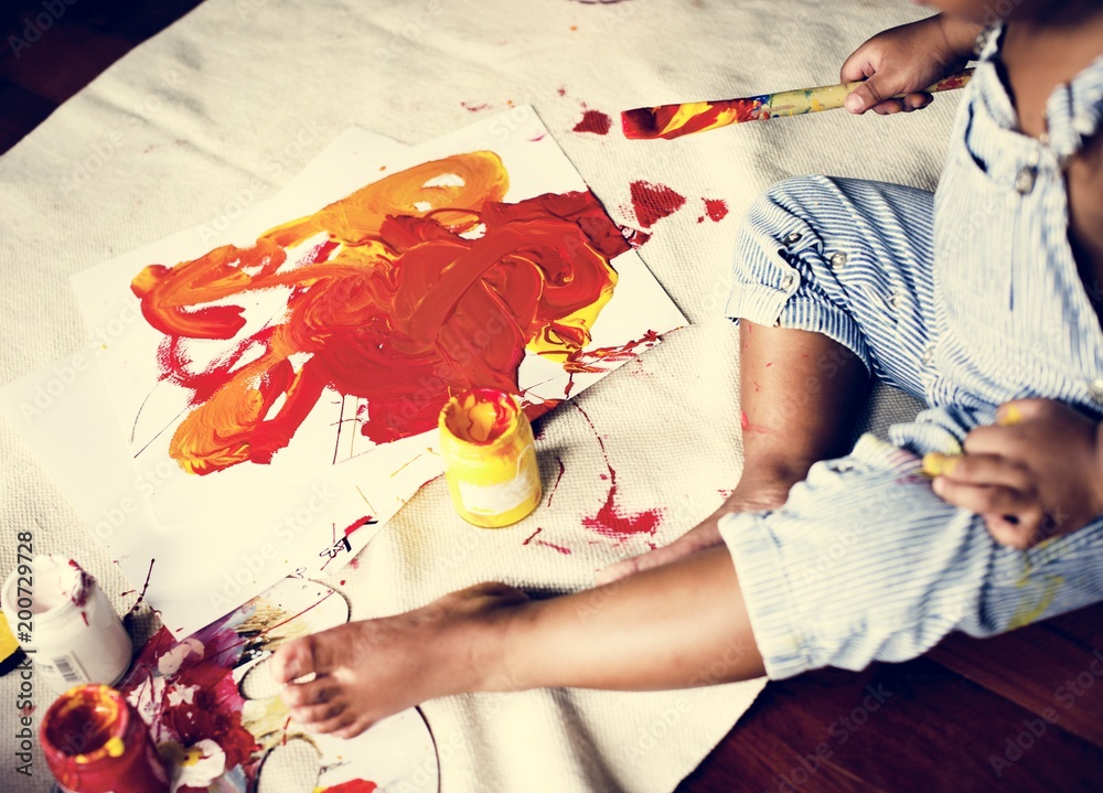 Fototapeta premium Black kid enjoying his painting