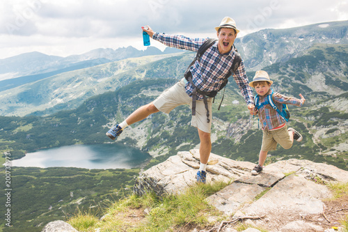 Father and son traveling in Rila mountains Bulgaria