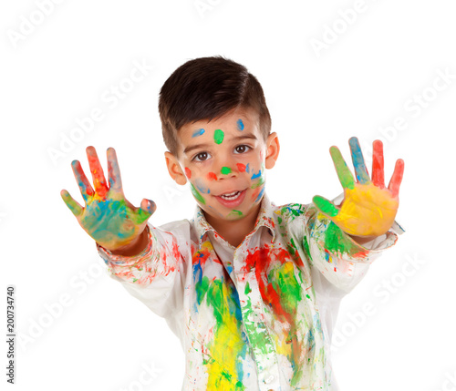 Funny boy with hands and face full of paint