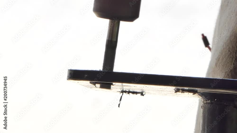 Man using a steel drill reaming metal and make the surface smooth. Metalworking, industrial background. Man using a steel drill reaming metal and make the surface smooth. Metalworking, industrial background.